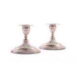 A pair of Victorian silver dwarf dressing table candlesticks. London 1883 by Bradbury & Henderson.