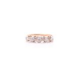 A five stone half hoop diamond ring; the graduated mixed old brilliant cut stones in carved claw