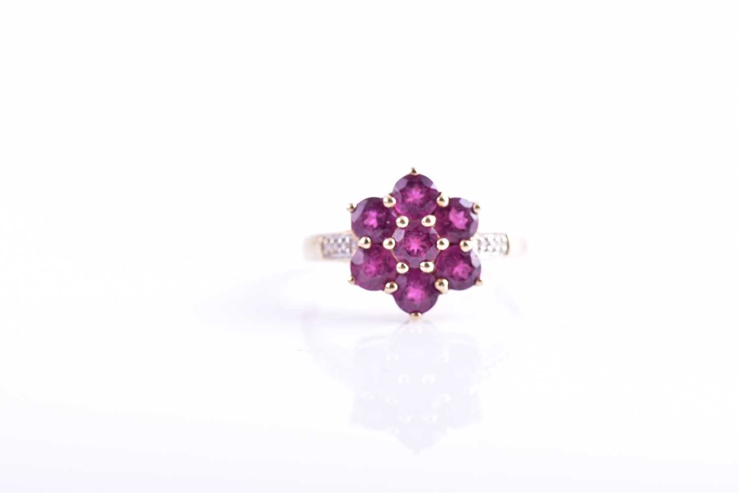 A 9ct yellow gold, diamond, and rhodalite garnet floral cluster ring set with seven round-cut