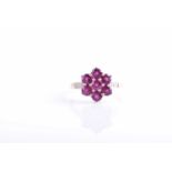 A 9ct yellow gold, diamond, and rhodalite garnet floral cluster ring set with seven round-cut