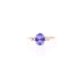 A 14ct yellow gold, tanzanite and diamond ring, set with a mixed oval-cut tanzanite measuring 8.5