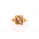 A yellow metal signet ring, with rectangular mount with engraved decoration, unmarked, size R.