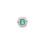 A platinum, diamond, and emerald ring, set with an emerald-cut emerald of approximately 1.60 carats,