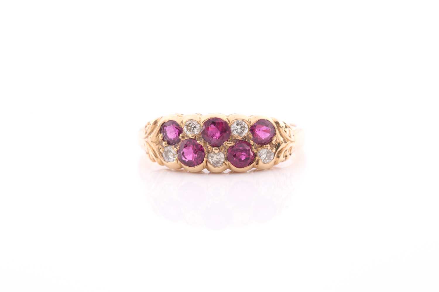 An 18ct yellow gold, diamond, and ruby ring, rubover set with mixed round-cut rubies and old-cut