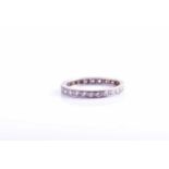 A platinum and diamond eternity ring, set with round brilliant-cut diamonds, hallmarked to side of