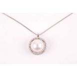 A diamond and pearl pendant, the round white pearl within a double halo border of round-cut