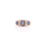 An 18ct yellow gold, diamond, and sapphire ring, set with three sapphires and four small diamonds,
