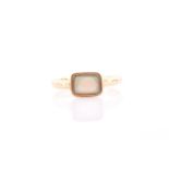 An 18ct yellow gold and opal ring, the rectangular mount inset with an opal plaque, the mount