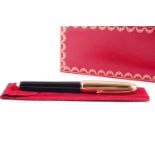 Cartier. A gold plated Pasha de Cartier fountain pen; with ribbed screw off of cover; black body and