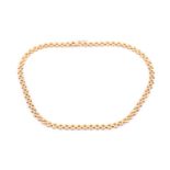 An 18ct yellow gold brick-link articulated necklace, approximately 42 cm long.Condition report: 25g