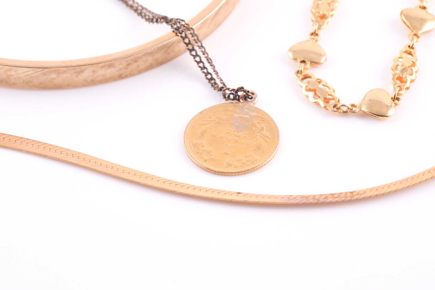 A bangle with textured finish stamped '14k'; an American gold 1 dollarcoin gold with loop surmount - Image 2 of 3