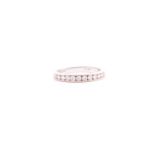 A twelve stone half hoop diamond eternity ring; the round brilliant cut diamonds in 18 carat white