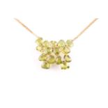 A peridot pendant; with centre composed of five three stone foliate clusters each set with the heart