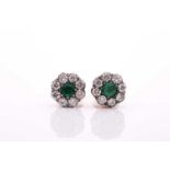 A pair of diamond and emerald floral cluster earrings, approximately 7.5 mm diameter, silvered