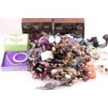 A box of various costume jewellery items, including various beaded necklaces and bracelets, white