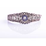An early 20th century diamond and sapphire bracelet, the articulated mount centred with an old-cut