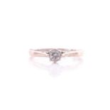 A single stone diamond ring, the round brilliant cut diamond in eight claw mount to a plain 18 carat