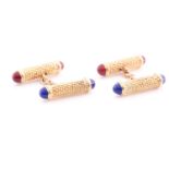 A pair of yellow metal textured baton cufflinks, with blue and red enamel terminals, indistinct