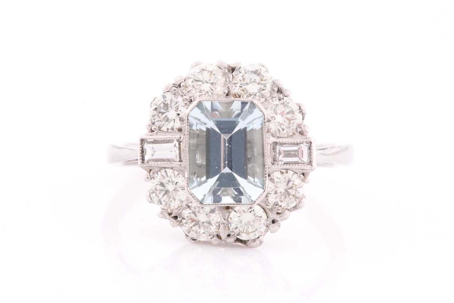 A platinum, diamond, and aquamarine ring, set with an emerald-cut aquamarine of approximately 1.20