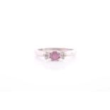 A pink sapphire and diamond three stone half hoop ring; the central circular cut pink sapphire