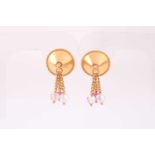 A pair of yellow metal and paste gemstone earrings, the domed mounts with faceted bead tassels,