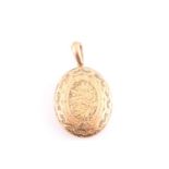 A Victorian yellow metal locket, the oval case with engraved decoration, hinged opening, interior