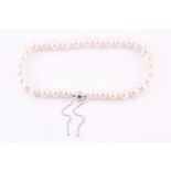 A cultured white pearl necklace, with adjustable magnetic silver clasp, the pearls measuring