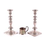 A pair of late 19th century Polish(?) white metal table candlesticks with square bases and removable