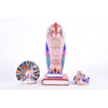 A large Herend porcelain figure of an owl seated on a pile of books, 31 cm high. Together with a