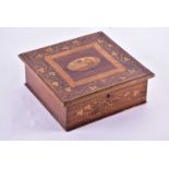 A 19th century Irish Killarney ware arbutus wood lace box, the hinged cover typically inlaid with