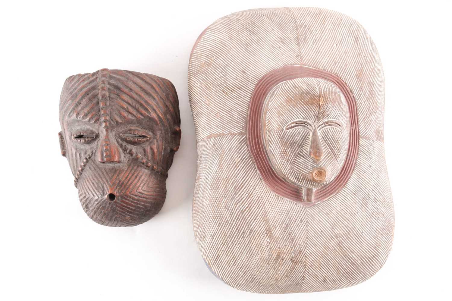 A Luba mask and shield, Democratic Republic of Congo, each with carved linear decoration, the mask