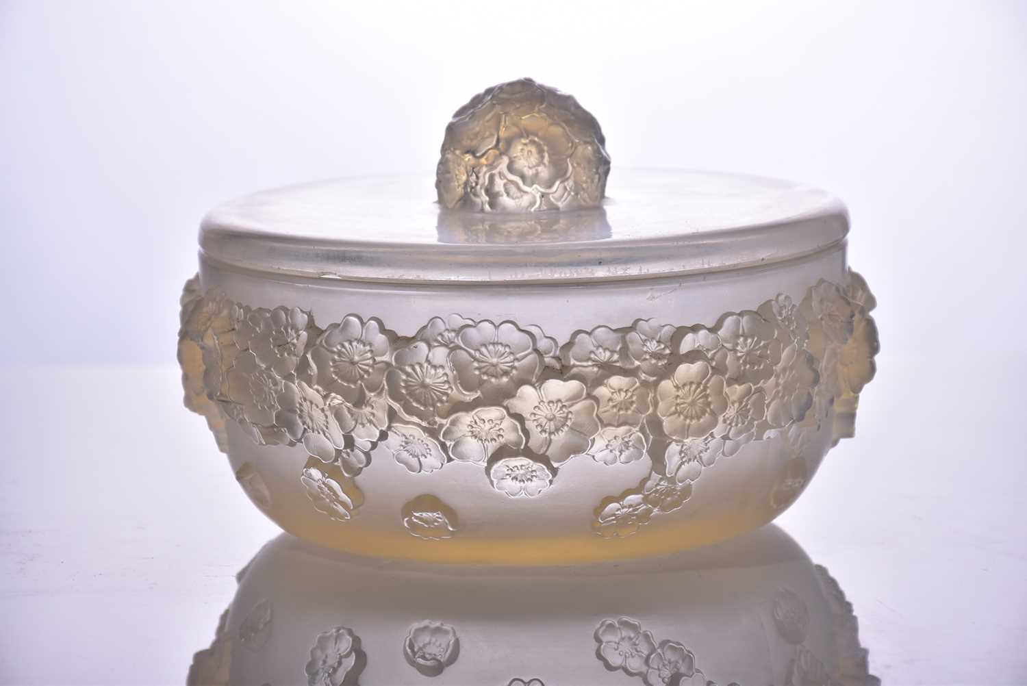 A Lalique "Primaveres" pattern circular powder jar and cover. Bearing moulded R.Lalique mark to