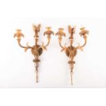A pair of early 19th century style ormolu two branch wall sconces fashioned as a pair of