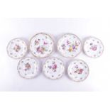 A set of seven hand-painted Meissen plates, 20th century, each with floral sprays on an ivory ground
