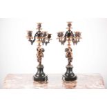 A pair 19th-century French patinated bronze and ormolu figural candelabra, each with four fruiting