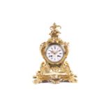 A French 19th-century gilt bronze 8-day rococo mantle clock of cartouche form with fruiting vine