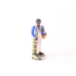 A 19th century Russian Kozlov porcelain figure, depicting a finely dressed African man, holding a