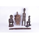 Five items of 20th century tribal art, comprising a face mark, figures and others, the largest 47 cm