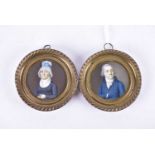 A pair of 19th-century German portrait miniatures on ivory, depicting a man and a woman, 6.7 cm
