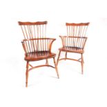 A pair of craftsmen made 20th century "Comb Back" ash and elm Windsor armchairs with cupids bow