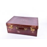 An early 20th century crocodile skin dressing case, by Goldsmiths and Silversmiths Company, named as