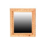 An Italianate carved wood and gilt gesso framed rectangular wall mirror. The moulded frame with a