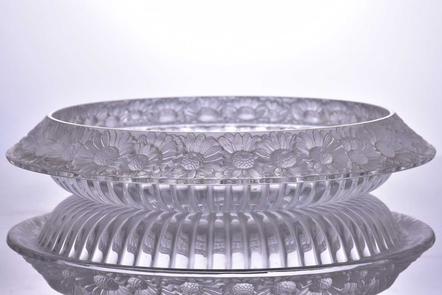 A Lalique 'Marguerites' pattern circular table centre with a frosted and moulded border, bearing