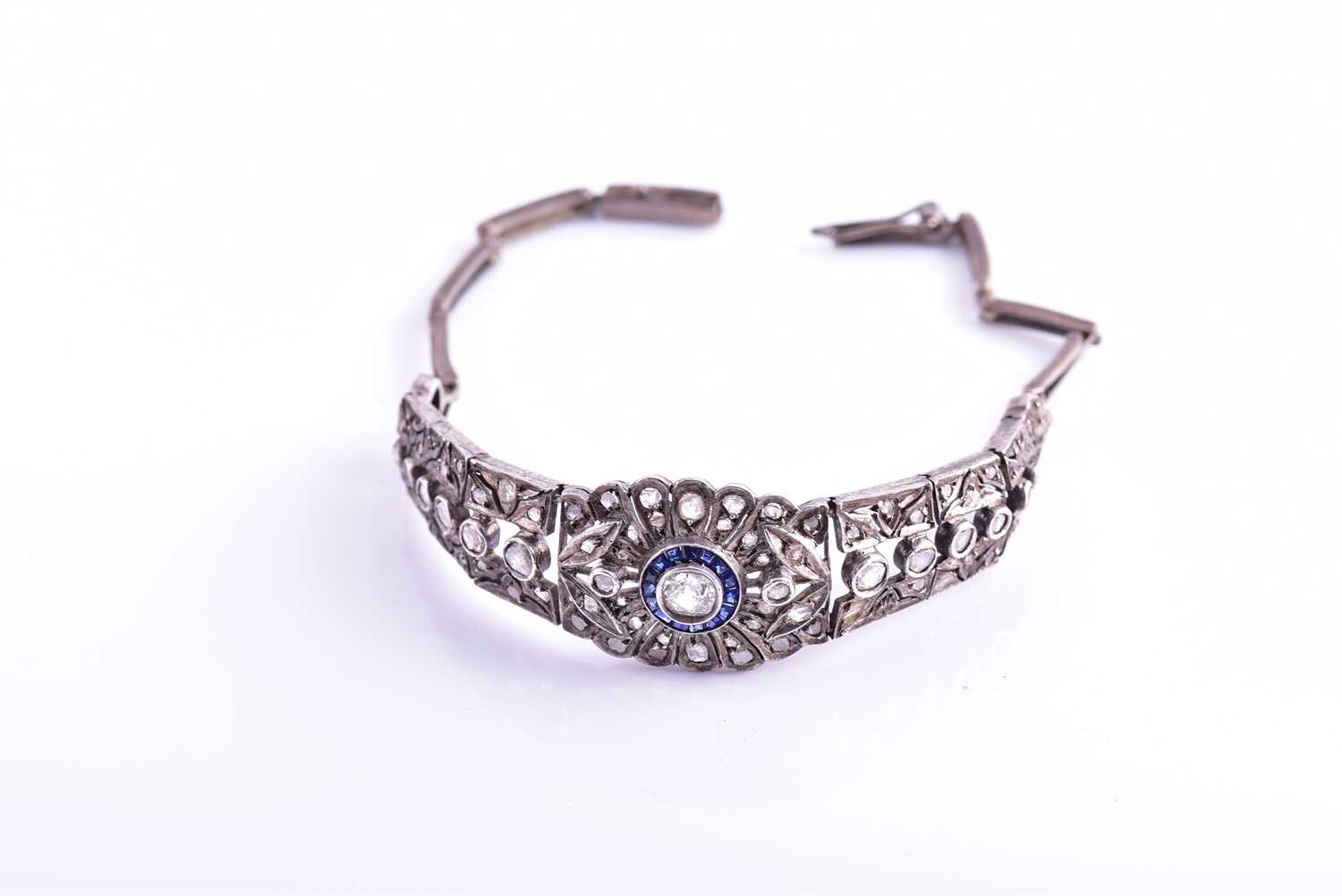 An early 20th century diamond and sapphire bracelet, the articulated mount centred with an old-cut - Image 7 of 8