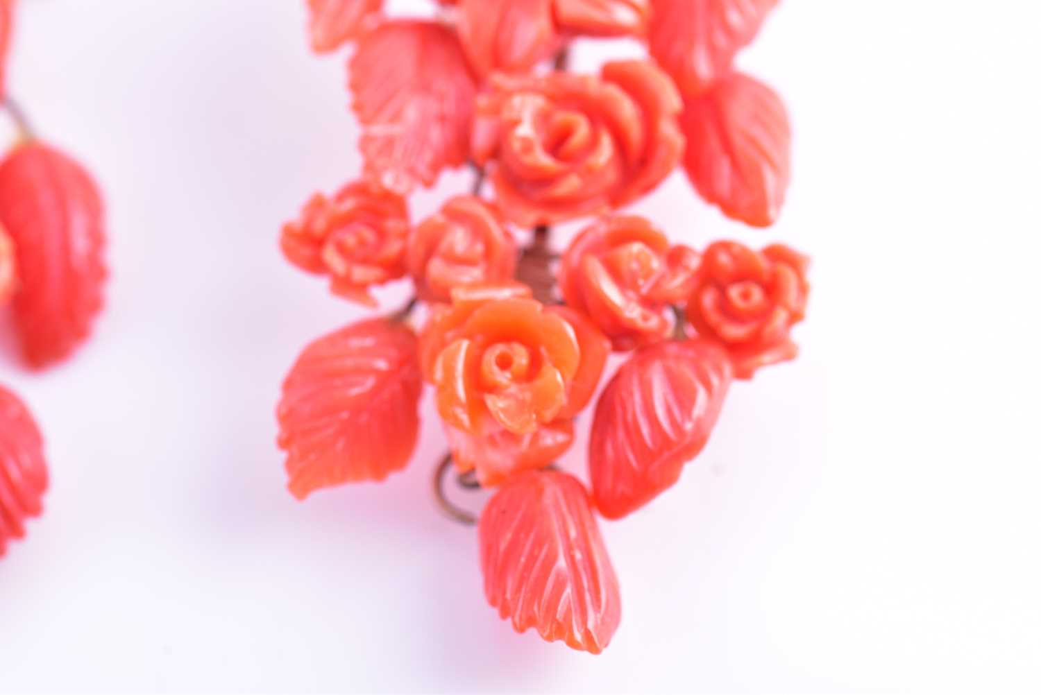 A pair of yellow metal and carved coral drop earrings, wire-set with foliate and floral carved red - Image 5 of 6