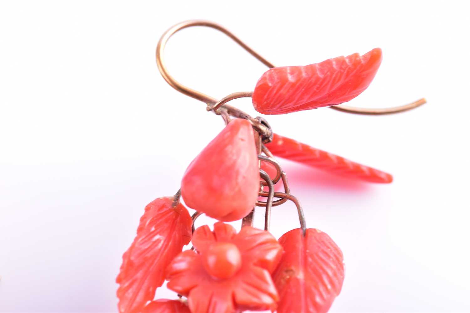 A pair of yellow metal and carved coral drop earrings, wire-set with foliate and floral carved red - Image 6 of 6