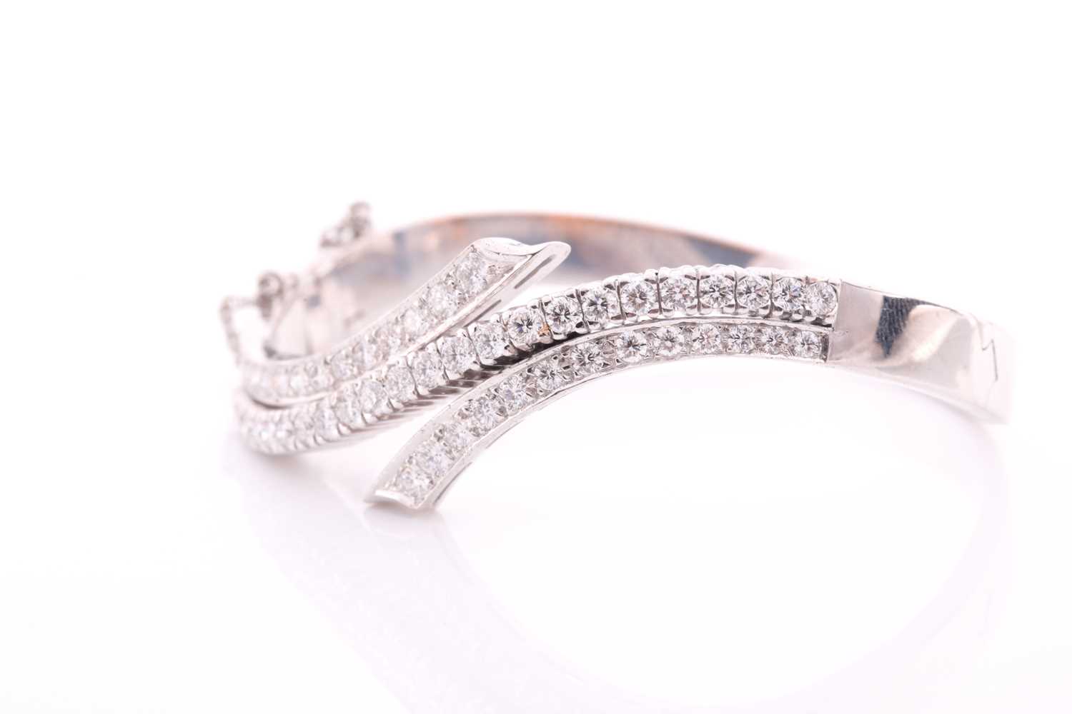 A diamond bangle of crossover design, inset with graduated round brilliant-cut diamonds of - Image 4 of 5