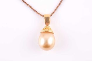 A yellow metal and South Sea pearl pendant necklace, set with a golden pearl, (the unmarked mount