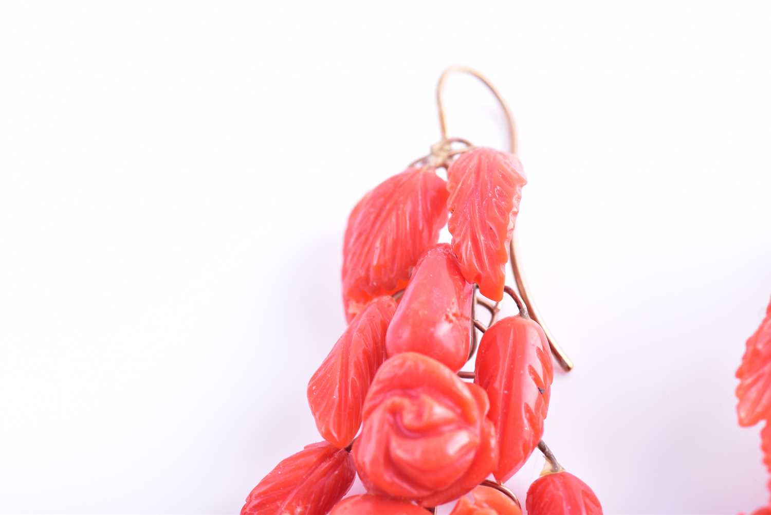 A pair of yellow metal and carved coral drop earrings, wire-set with foliate and floral carved red - Image 3 of 6