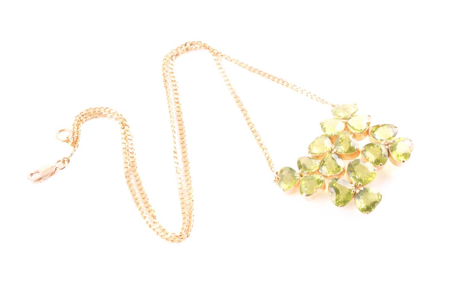 A peridot pendant; with centre composed of five three stone foliate clusters each set with the heart - Image 5 of 5